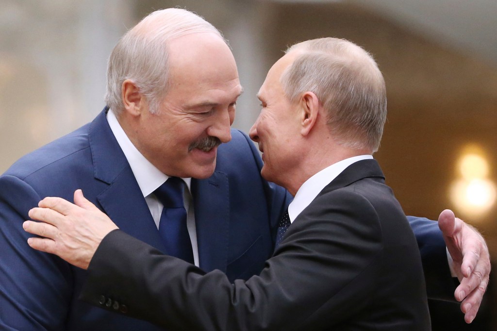 In this file photo taken on Thursday, Nov. 30, 2017, Belarusian President Alexander Lukashenko, left, greets Russian President Vladimir Putin during the Collective Security Council of the Collective Security Treaty Organization (CSTO) summit in Minsk, Belarus.