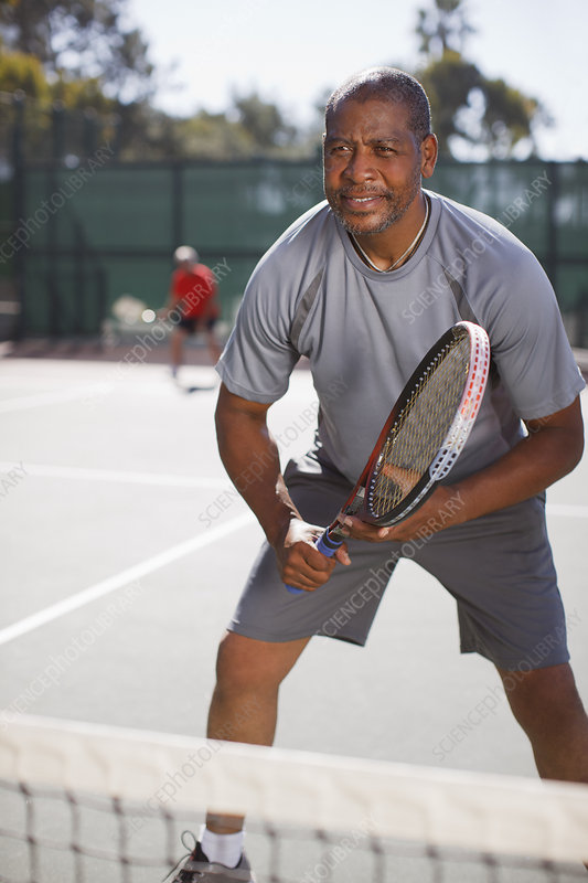 F0135357-Older_man_playing_tennis_on_court.jpg