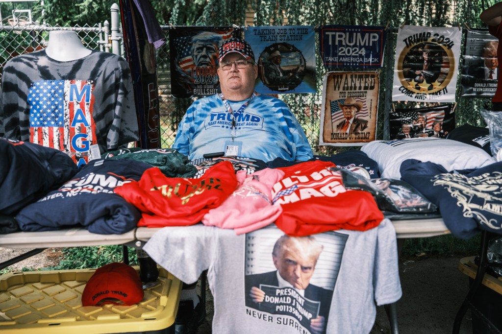 Steve Scanlan, 60, selling Trump merchandise at a stand.