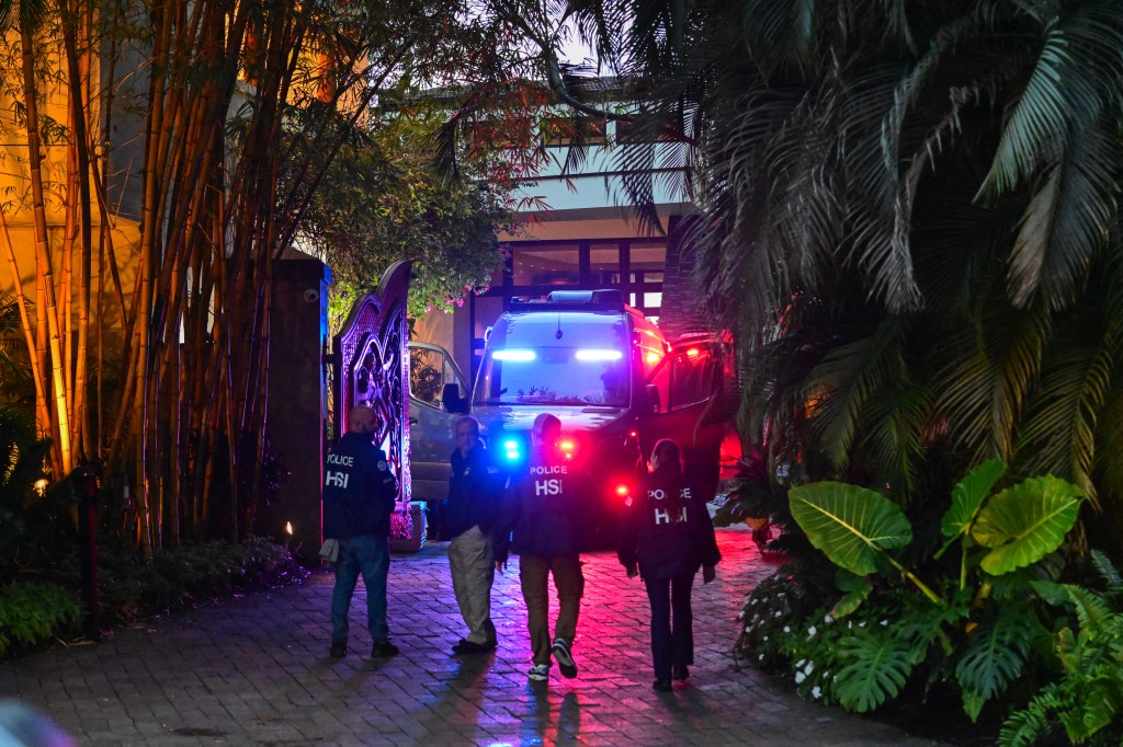 Homeland Security Investigation agents are seen at the entrance of US producer and musician Sean Diddy Combs's home.