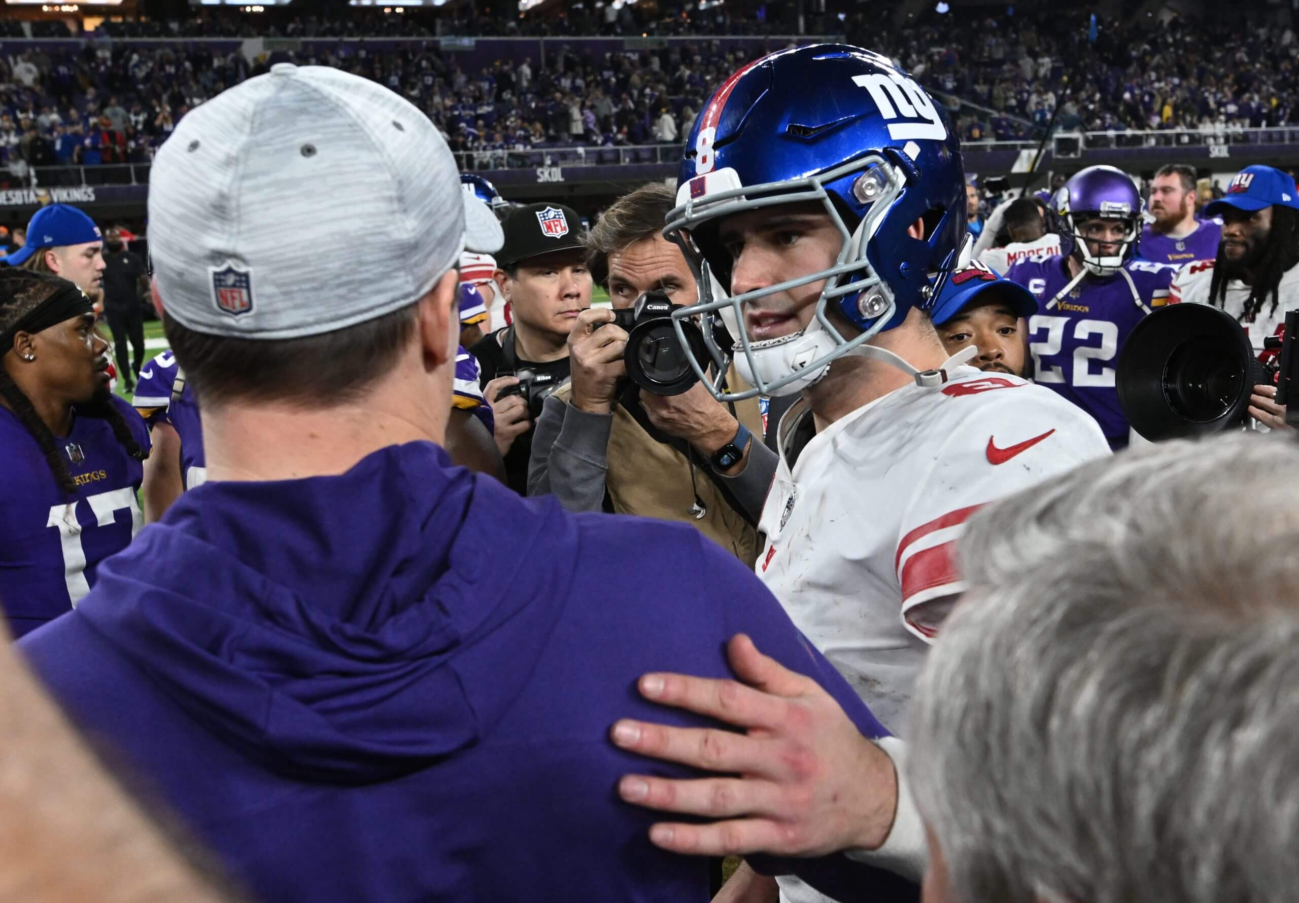 Daniel Jones of the New York Giants and head coach Kevin O'Connell of the Minnesota Vikings talk after the NFC Wild Card playoff game at U.S. Bank Stadium on January 15, 2023 in Minneapolis, Minnesota.