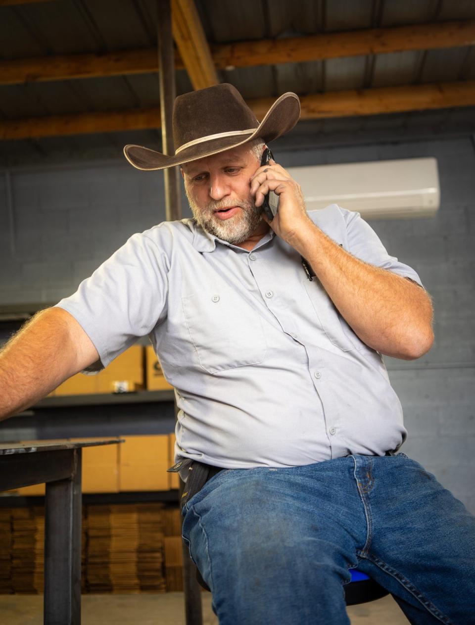 Bundy on the phone in his workspace in October, 2024 (Tom Richell / The Independent)