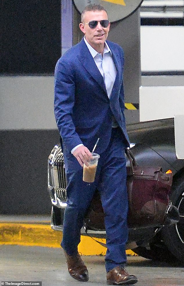 88275961-13720033-Ben_Affleck_was_spotted_smirking_as_he_emerged_from_his_office_i-a-50_1723059909784.jpg