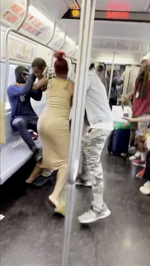 Jordan Williams in blue outfit struggling with Devictor Ouedraogo in black and white plaid shirt on a train moments before an incident