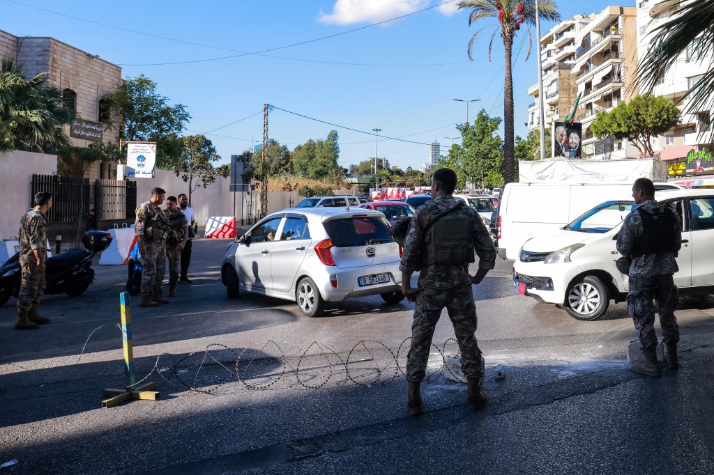 Lebanese army soldiers block an entrance of a Beirut southern suburb on September 17, 2024, after explosions hit locations in several Hezbollah strongholds.