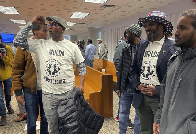 Ride-hailing drivers celebrate in Minneapolis, Thursday, March 7, 2024, immediately after Minneapolis City Council members voted to pass a measure that would increase wages to drivers of ride-hailing companies, including Uber and Lyft, to an equivalent of more than $15 an hour. Opponents say this may increase costs to customers and increase fears that Uber and Lyft will follow through on their threats to leave the area altogether. (AP Photo/Trisha Ahmed)