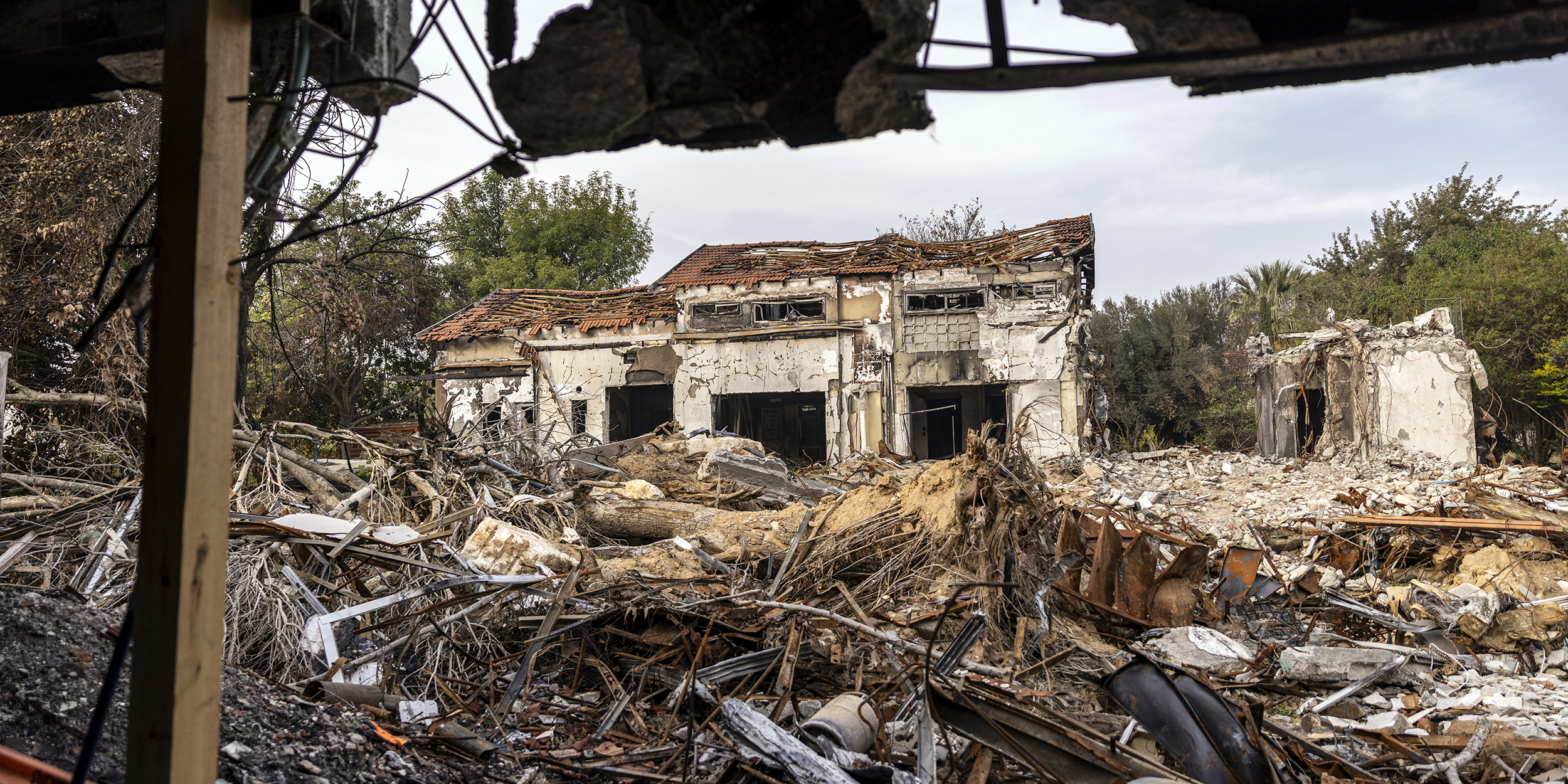 BE'ERI, ISRAEL - DECEMBER 20: Destroyed houses are seen on December 20, 2023 in Be'eri, Israel. Families and supporters of hostages kidnapped by Hamas on Oct. 7 joined a tour of Kibbutz Be'eri held for journalists to mark 75 days since the attack. (Photo by Maja Hitij/Getty Images)