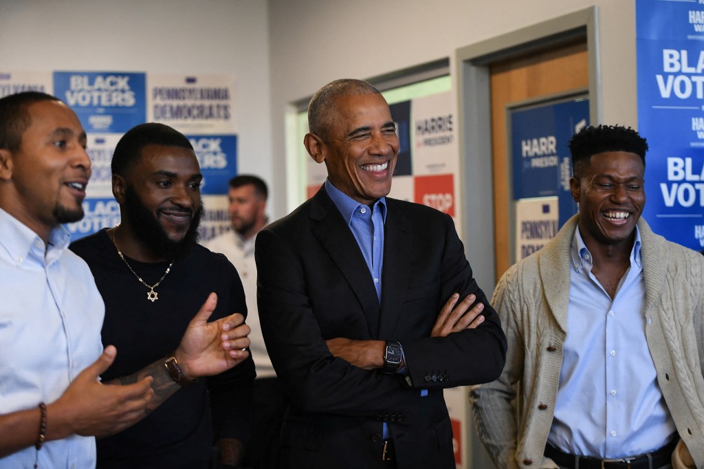 Former President Barack Obama laughs as he listens to an introduction at a campaign field office in East Liberty, ahead of a rally in support of Vice President Kamala Harris, in Pittsburgh, Pennsylvania, U.S., on Oct. 10, 2024.