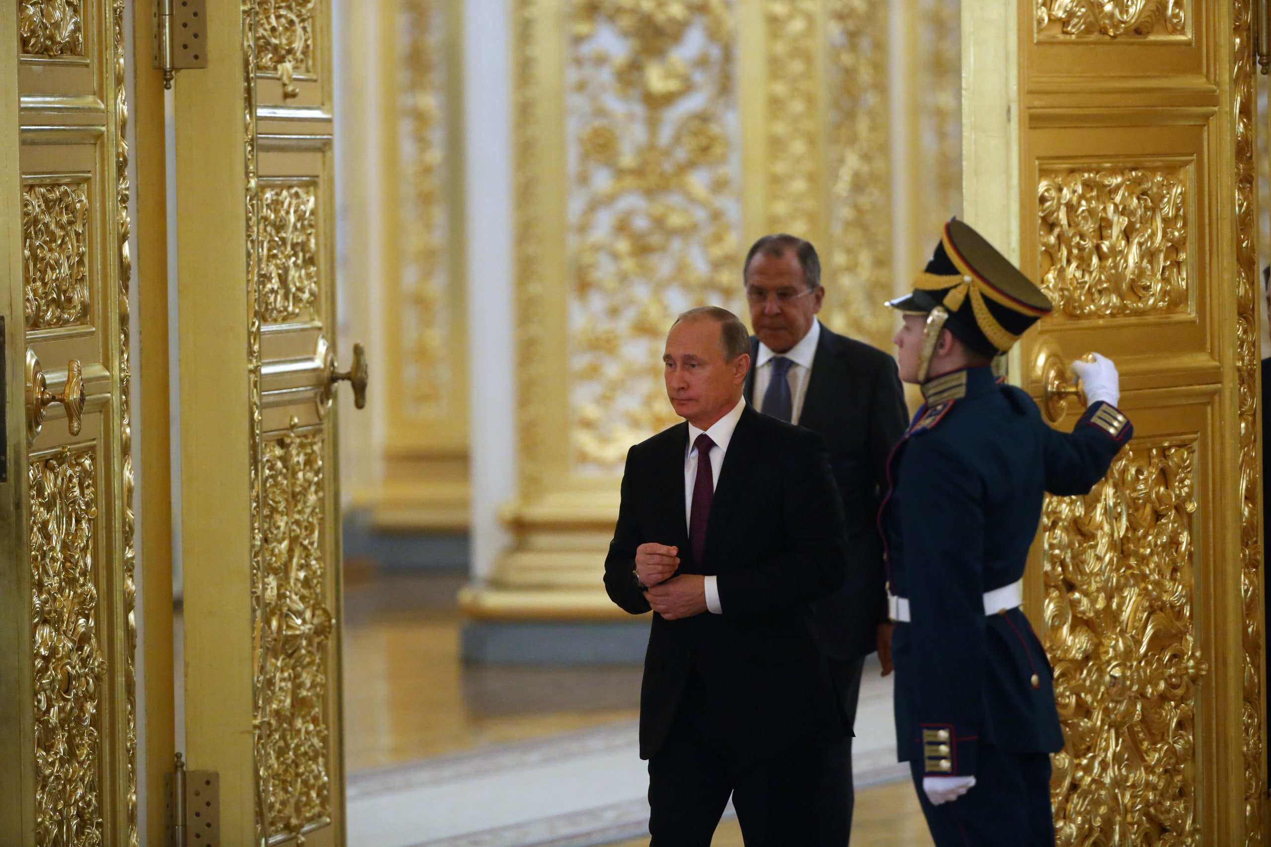 Image may contain Vladimir Putin Sergey Lavrov Accessories Formal Wear Tie Adult Person Clothing Glove and Hat