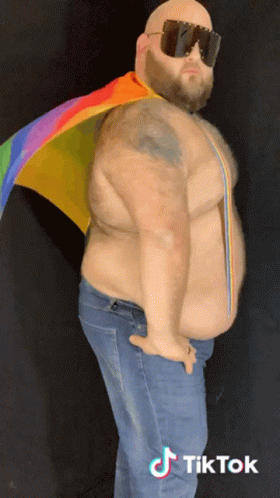 a man wearing sunglasses and a rainbow flag has a tiktok logo on his bottom right a man wearing sunglasses and a rainbow flag has a tiktok logo on his bottom right