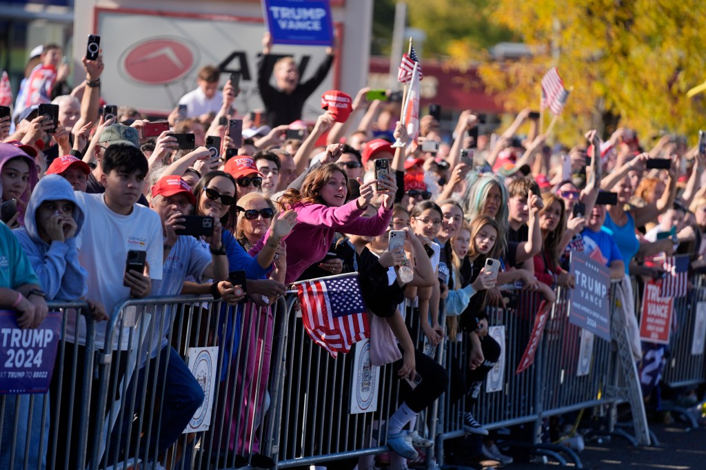 Supporters of Republican presidential nominee former President Donald Trump cheer outside of a McDonald's in Feasterville-Trevose, Pa.