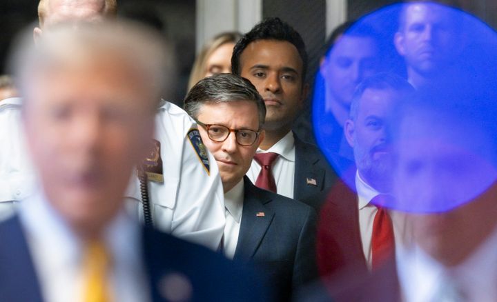 US Speaker of the House Mike Johnson (C) and former presidential candidate Vivek Ramaswamy (C behind Johnson) listen as former President Donald Trump (L) speaks to reporters as he arrives to attend his trial for allegedly covering up hush money payments linked to extramarital affairs, at Manhattan Criminal Court in New York City, on May 14, 2024. Trump's former personal attorney Michael Cohen returns to the witness stand on Tuesday for what is expected to be a tough grilling by the ex-president's lawyers at his historic hush money trial. (Photo by JUSTIN LANE / POOL / AFP) (Photo by JUSTIN LANE/POOL/AFP via Getty Images)