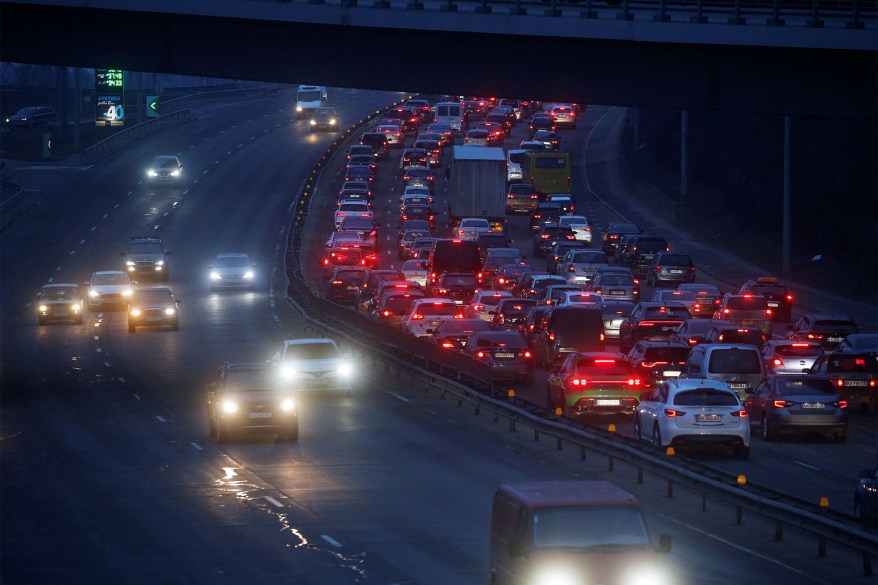 Cars drive towards the exit of the city after Russian President Vladimir Putin authorized a military operation in eastern Ukraine, in Kyiv