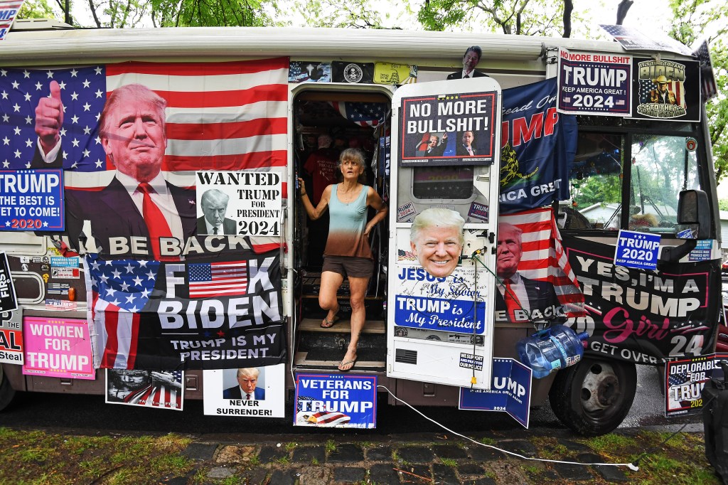 A Trump fan in an RV with signs and flags supporting the former president.