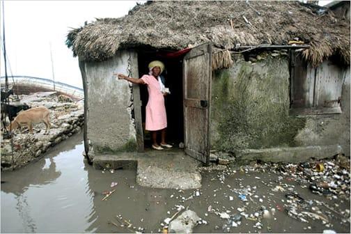 haiti-les-cayes-woman-goats-home-flooded.jpg