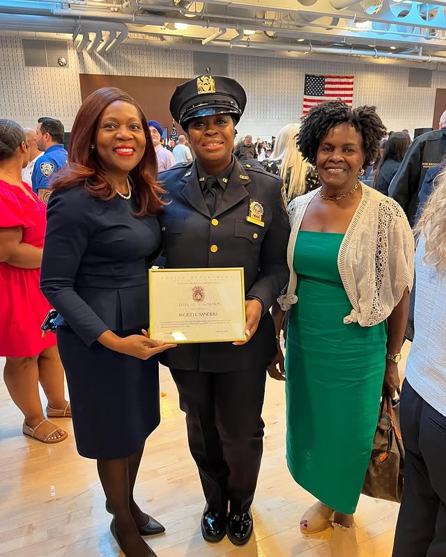 Deputy Commissioner Lisa White and Detective Ingrid Sanders holding a promotion certificate with an unidentified woman