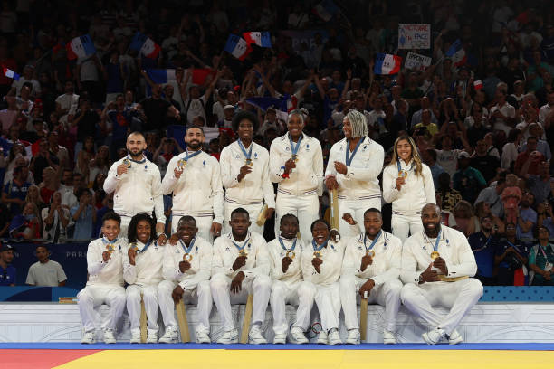 topshot-gold-medallists-team-france-pose-for-a-photo-after-the-podium-of-the-judo-mixed-team.jpg