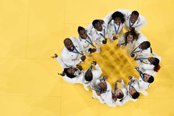 an-overview-shows-french-national-judo-team-posing-after-winning-the-judo-mixed-team-gold.jpg