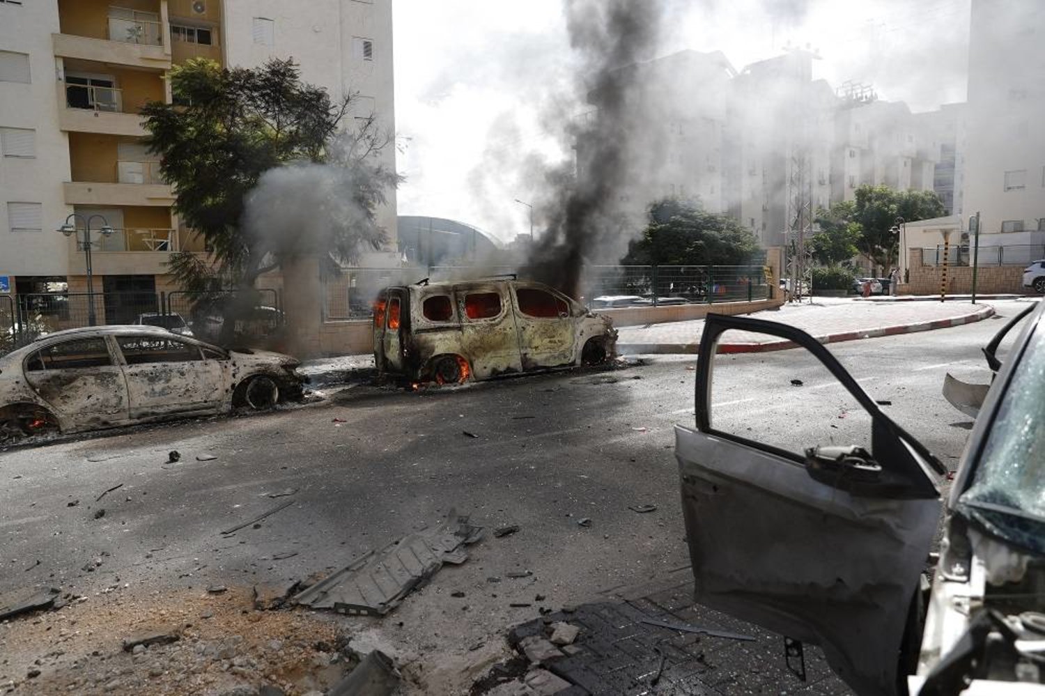 Wrecked cars and damaged buildings in the Israeli city of Ashkelon following rocket launches from Gaza, 07 October 2023. (EPA)