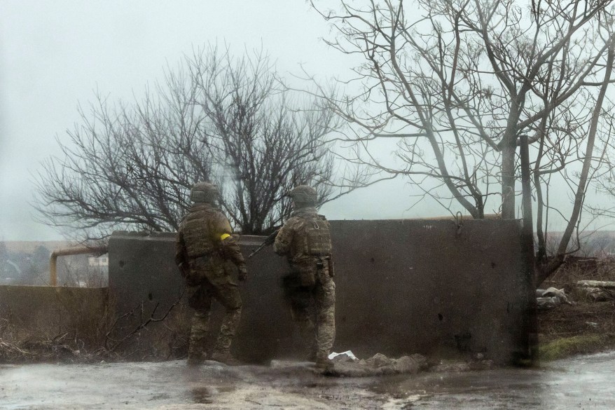 Service members of the Ukrainian armed forces take position after Russian President Vladimir Putin authorized military operation in eastern Ukraine, in Mariupol