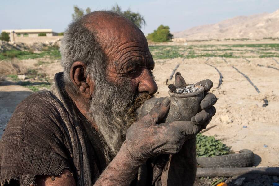 Amou Haji Smoking A Pipe