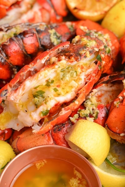 close up lobster tail with garlic butter sauce