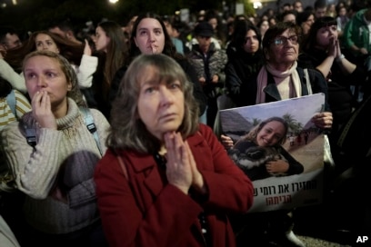 Relatives and friends of people killed and abducted by Hamas and taken into Gaza, one of them holding a photograph of Romi Gonen, react to the news during a gather in Tel Aviv, Israel, Jan. 19, 2025.