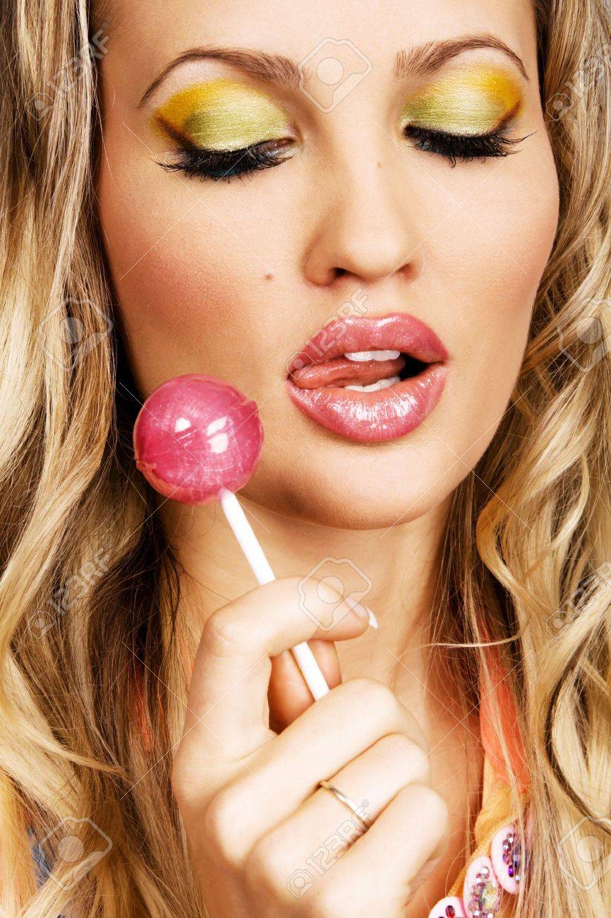 5917576-Beutiful-woman-with-creative-makeup-holding-a-candy-closeup-portrait-Stock-Photo.jpg