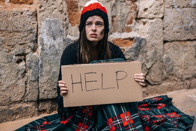 young-depressed-homeless-girl-woman-sitting-alone-fence-keep-wall-outside-cold-weather-she-asks-help_195549-4693.jpg