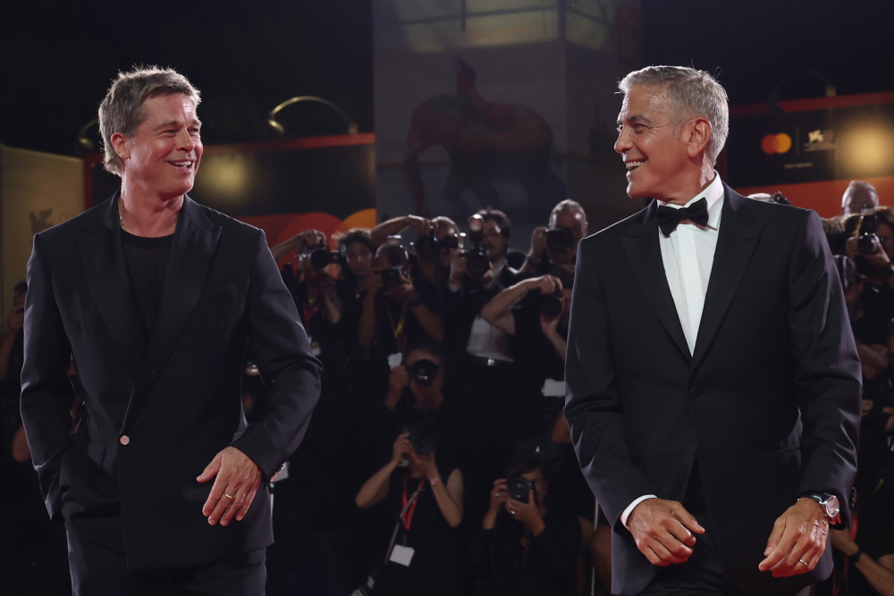 VENICE, ITALY - SEPTEMBER 01: Brad Pitt and George Clooney attend the Wolfs red carpet during the 81st Venice International Film Festival on September 01, 2024 in Venice, Italy. (Photo by Vittorio Zunino Celotto/Getty Images)