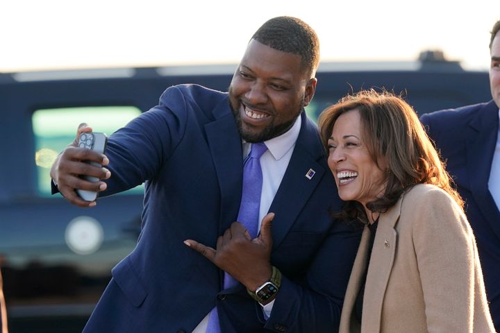 Durham, North Carolina, Mayor Leonardo Williams (left) takes a selfie with Democratic presidential nominee Vice President Kamala Harris as she arrives at Raleigh-Durham International Airport in Morrisville on Saturday.