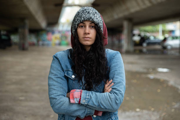 young-depressed-homeless-girl-or-woman-standing-alone-under-the-bridge-on-the-street-on-the.jpg