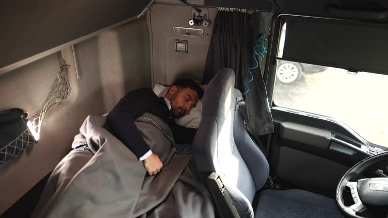 truck-driver-sleeping-in-cabin-bed-on-truck-stop.jpg