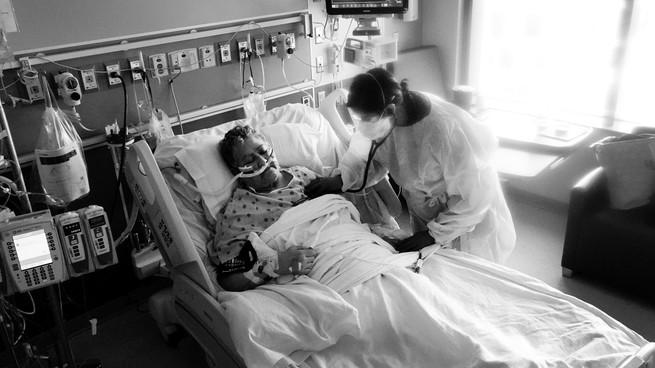 a respiratory therapist treats a COVID-19 patient