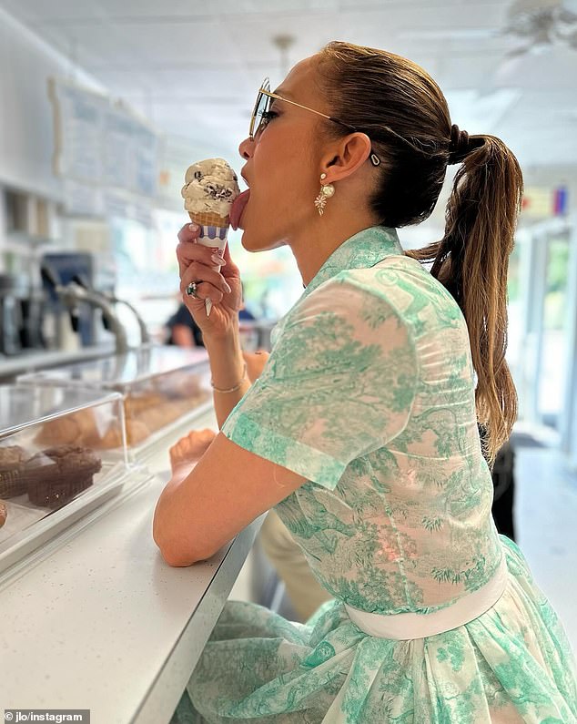 89146179-13800713-JLo_could_be_seen_rocking_a_1950s_chic_floral_dress_while_enjoyi-a-87_1725153016646.jpg